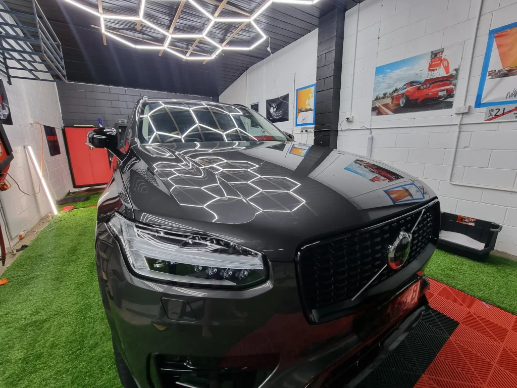 Grey SUV reflecting the hexagon lights after ceramic coating