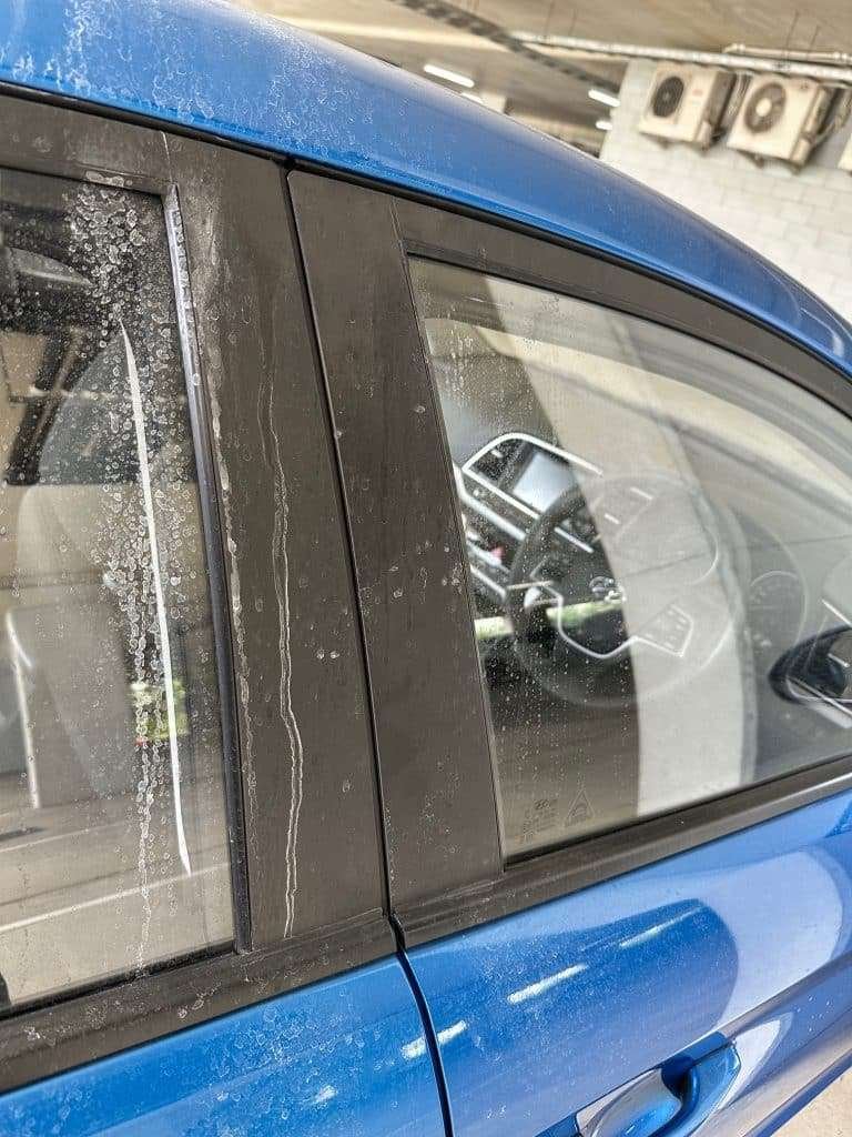 Blue car door and window pillar after detailing