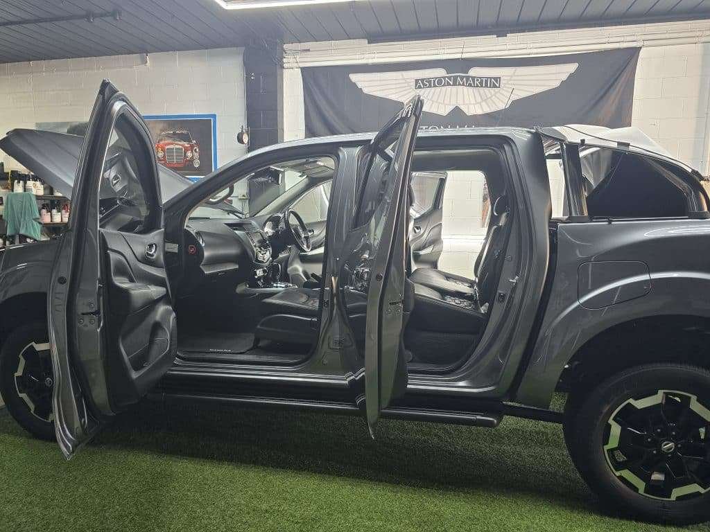 Ute with all doors open during a full interior detail
