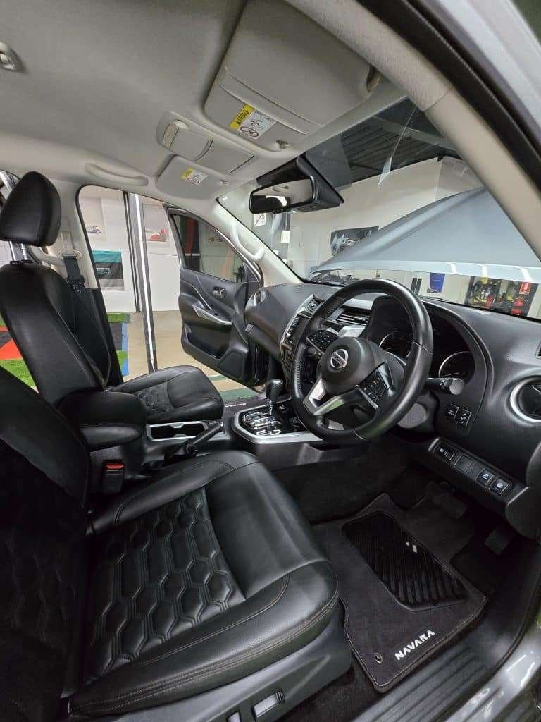 Leather front seat and dashboard after interior detailing