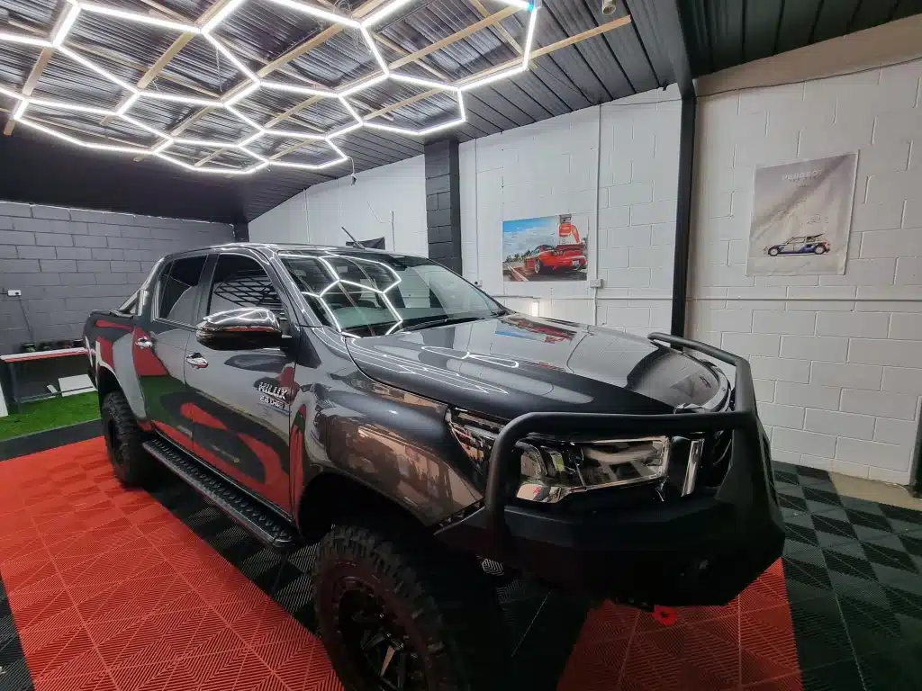 Black 4WD ute with bull bar after a full detail and ceramic coating