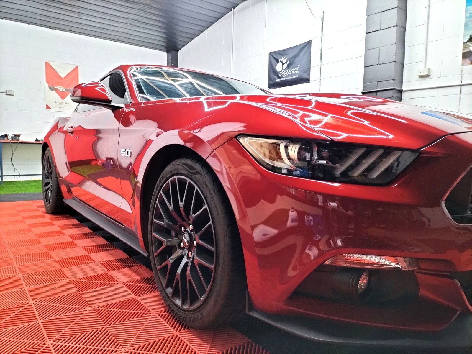 Deep red Ford Mustang GT with a mirror gloss finish after paint correction