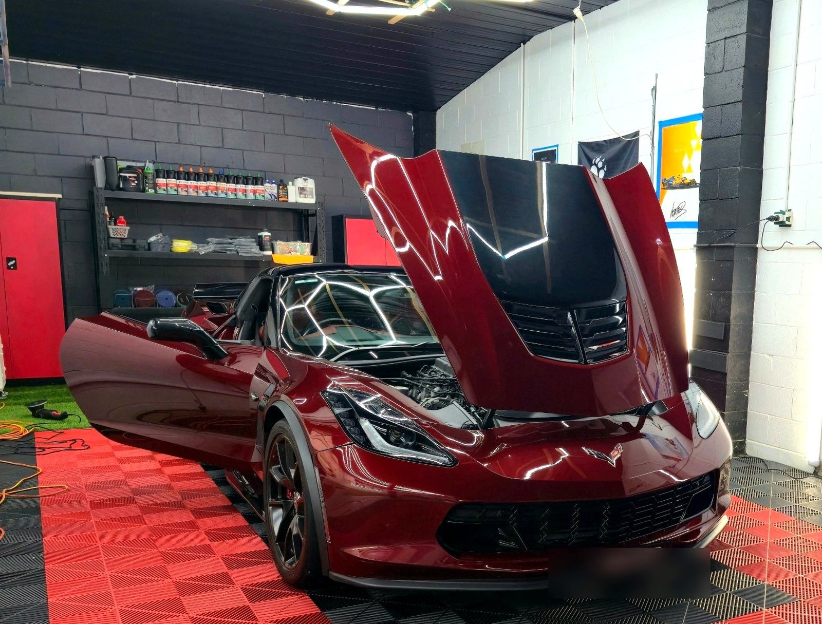 Deep red Corvette with bonnet and door open, glossy paintwork after a full premium detail